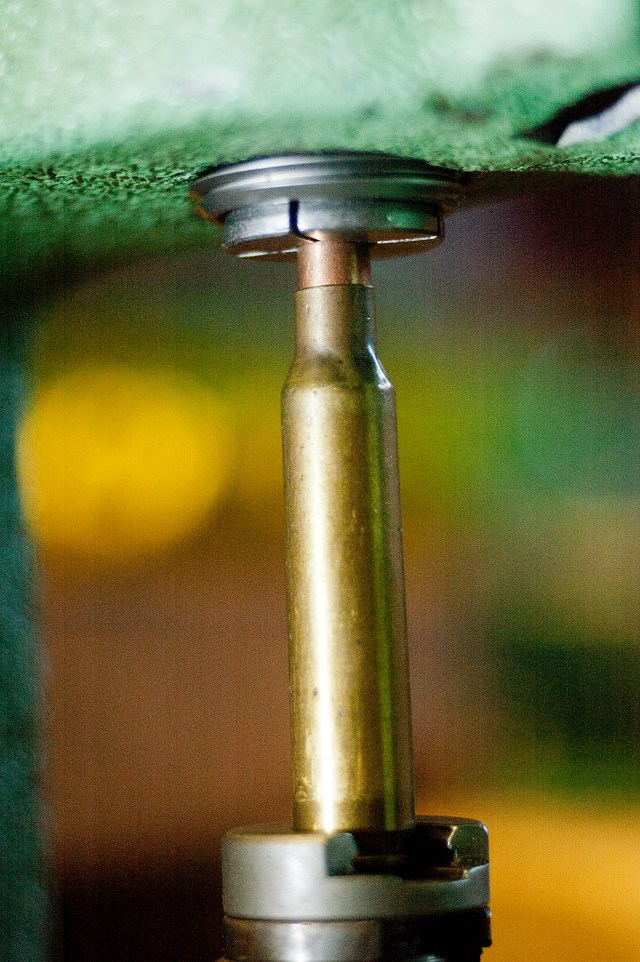 Raise the ram inserting the bullet into the collet.