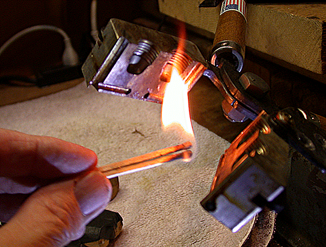 Showing the smoking of a mould with a match