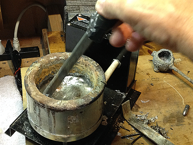 Showing flux being stirred into the melt