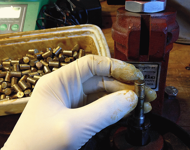 Showing insertion of slug into the Lee sizing die.